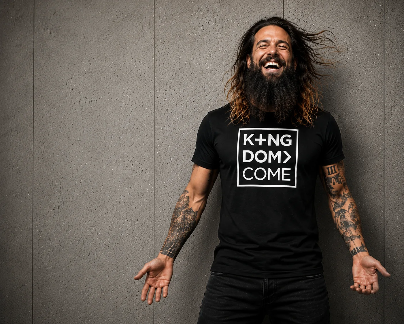 Man laughing with arms open wearing the Kingdom Come logo tee